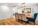 Bright dining room featuring a long wooden table with seating for six and hardwood floors at 5919 S Newberry Rd, Tempe, AZ 85283