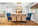 Formal dining area featuring contemporary chandelier, modern mirror, and seating for six at 5919 S Newberry Rd, Tempe, AZ 85283