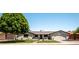 Exterior of single story house featuring a well maintained lawn, nice landscaping, and brick driveway at 5919 S Newberry Rd, Tempe, AZ 85283