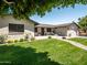 Beautiful single story home with a green lawn, brick pathway, black framed windows, and two car garage at 5919 S Newberry Rd, Tempe, AZ 85283