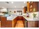Modern kitchen with light wood floors, walnut cabinets and white countertops at 5919 S Newberry Rd, Tempe, AZ 85283