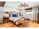Main bedroom features a king size bed, wood floors and ceiling fan at 5919 S Newberry Rd, Tempe, AZ 85283
