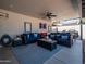 Comfortable outdoor patio featuring plush seating and ceiling fan for relaxed entertaining at 5919 S Newberry Rd, Tempe, AZ 85283