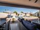 Charming backyard showcasing a pool with sun loungers, striped umbrellas, and comfortable outdoor seating at 5919 S Newberry Rd, Tempe, AZ 85283