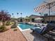 Lounge chairs and sun umbrellas enhance the appeal of this backyard swimming pool and patio at 5919 S Newberry Rd, Tempe, AZ 85283