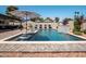 Beautiful pool with a waterfall feature and striped umbrellas create a relaxing outdoor oasis at 5919 S Newberry Rd, Tempe, AZ 85283