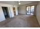 Spacious bedroom with sliding glass doors to patio, walk-in closet, and ensuite bathroom at 5998 N 78Th St # 222, Scottsdale, AZ 85250