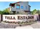 Beautiful community sign with flowers in front of two-story home in Villa Estados at 5998 N 78Th St # 222, Scottsdale, AZ 85250