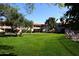 This beautiful, lush grassy area is surrounded by trees and community buildings at 5998 N 78Th St # 222, Scottsdale, AZ 85250