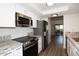 Modern kitchen boasts stainless steel appliances, granite countertops, and white cabinetry at 5998 N 78Th St # 222, Scottsdale, AZ 85250
