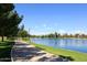 Picturesque lakeside path bordered by lush green lawns and tranquil water, ideal for leisurely strolls at 5998 N 78Th St # 222, Scottsdale, AZ 85250