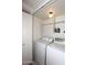 This functional laundry room features a washer, a dryer, and shelves for storage at 5998 N 78Th St # 222, Scottsdale, AZ 85250