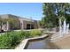 Exterior view of the library with a serene water feature and lush greenery in the foreground at 5998 N 78Th St # 222, Scottsdale, AZ 85250