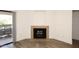 Charming fireplace in a living room with sliding glass doors that lead out to a balcony at 5998 N 78Th St # 222, Scottsdale, AZ 85250