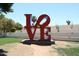 A 'LOVE' sculpture is a visually striking outdoor art installation with layered terraces in the background at 5998 N 78Th St # 222, Scottsdale, AZ 85250