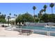 Serene Scottsdale park view with water fountain, mature trees, and American flag in the background at 5998 N 78Th St # 222, Scottsdale, AZ 85250