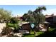 View of the pool and barbeque area with a mature olive tree at 5998 N 78Th St # 222, Scottsdale, AZ 85250