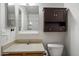 Standard bathroom featuring a vanity with sink, mirror, wall cabinet, and toilet at 7977 W Wacker Rd # 220, Peoria, AZ 85381