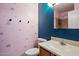 Bathroom with colorful wall art, and a vanity area with toilet and a mirrored wall at 7977 W Wacker Rd # 220, Peoria, AZ 85381
