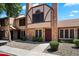 Charming townhome featuring brick facade, complemented by lush landscaping, creating a welcoming curb appeal at 7977 W Wacker Rd # 220, Peoria, AZ 85381