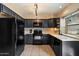 Well-equipped kitchen with sleek black appliances, tile flooring, and a bright window at 7977 W Wacker Rd # 220, Peoria, AZ 85381