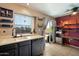 Bright kitchen features a sink, stainless steel dishwasher, and sliding glass doors to an outdoor patio at 7977 W Wacker Rd # 220, Peoria, AZ 85381