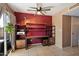 Bright office features a ceiling fan, desk, shelving unit and tile flooring at 7977 W Wacker Rd # 220, Peoria, AZ 85381