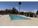 Community swimming pool surrounded by a deck, lounge area, and palm trees under blue skies at 7977 W Wacker Rd # 220, Peoria, AZ 85381