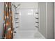 Clean white shower and tub combination featuring built-in shelving and shower curtain at 7977 W Wacker Rd # 220, Peoria, AZ 85381