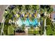 Aerial shot of luxury pool area with neatly arranged umbrellas, palm trees, and lounge chairs at 805 E La Palta St, Queen Creek, AZ 85140