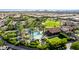 Aerial view of community pool, landscaping, homes, and distant mountains at 805 E La Palta St, Queen Creek, AZ 85140