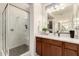 Modern bathroom featuring a glass enclosed shower, quartz countertop, and wood vanity at 805 E La Palta St, Queen Creek, AZ 85140