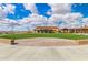 Outdoor area with a well-manicured lawn, brick pavers, and string lights near the community clubhouse at 805 E La Palta St, Queen Creek, AZ 85140