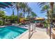 Picturesque community pool with lush landscaping, comfortable lounge seating, and shaded areas for residents' enjoyment at 805 E La Palta St, Queen Creek, AZ 85140