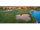 Aerial of lush golf course with sand traps and a tranquil lake in a beautiful community at 805 E La Palta St, Queen Creek, AZ 85140