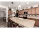 Well-appointed kitchen boasts granite countertops, stainless steel appliances, and a large island at 805 E La Palta St, Queen Creek, AZ 85140
