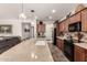 Open kitchen featuring a large granite island with seating and stainless steel appliances at 805 E La Palta St, Queen Creek, AZ 85140