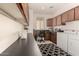 Laundry room boasts plenty of counter and cabinet space, plus sleek washer and dryer at 805 E La Palta St, Queen Creek, AZ 85140