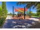 Well-maintained community playground with sun shades and nearby seating area surrounded by trees at 805 E La Palta St, Queen Creek, AZ 85140