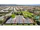 Aerial image featuring community tennis courts, a clubhouse, green spaces, and a picturesque residential area at 805 E La Palta St, Queen Creek, AZ 85140