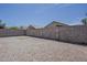 The gravel backyard is fully enclosed with a block fence, offering privacy at 8733 W Laurel Ln, Peoria, AZ 85345