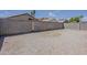 Spacious gravel backyard is enclosed by a block fence, providing a secure outdoor area at 8733 W Laurel Ln, Peoria, AZ 85345