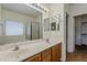 Bathroom with double sinks, large mirror, vanity lighting, and a separate room for the bath and shower at 8733 W Laurel Ln, Peoria, AZ 85345