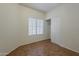Bedroom features tile flooring, neutral paint, a window, and closet at 8733 W Laurel Ln, Peoria, AZ 85345