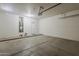 Spacious two car garage with cement floor and an adjacent door at 8733 W Laurel Ln, Peoria, AZ 85345