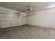A two car garage with a working door and cement floor at 8733 W Laurel Ln, Peoria, AZ 85345