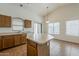 Open kitchen featuring an island, wood cabinets and plenty of counter space at 8733 W Laurel Ln, Peoria, AZ 85345