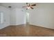 Spacious living room with tile flooring, ceiling fan, and natural light at 8733 W Laurel Ln, Peoria, AZ 85345