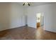 A spacious living room with ceramic tile floors that connects to an adjacent bathroom at 8733 W Laurel Ln, Peoria, AZ 85345
