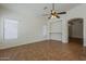 Spacious living room featuring tile flooring, neutral walls, and a ceiling fan fixture at 8733 W Laurel Ln, Peoria, AZ 85345